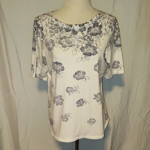 Talbots white cotton knit short sleeve top with a blue floral design. Size Large
